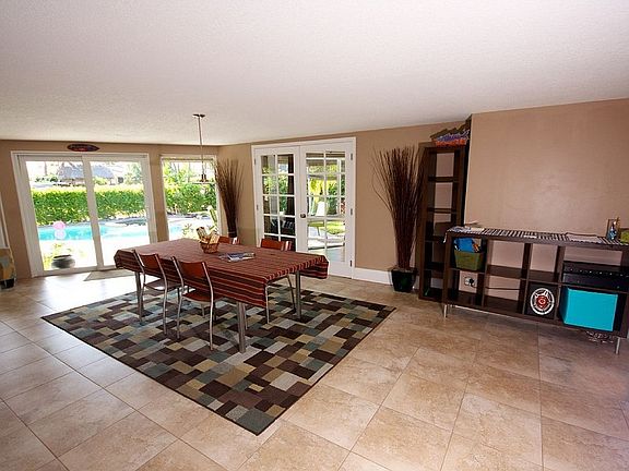 Dining or Florida room
						:
						Floor to ceiling windows overlook pool and waterfront views.