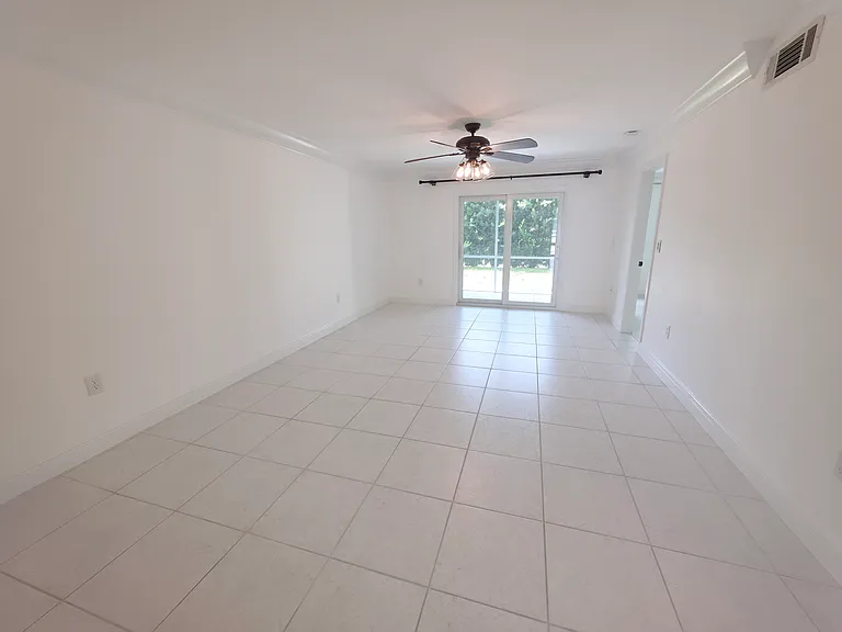 Living room and dining area. Impact glass slider opens up to lanai.