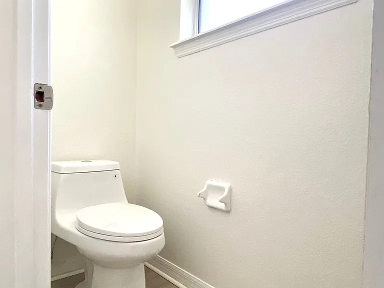 Private toilet room inside bathroom with new toilet