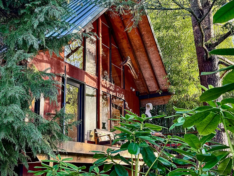 Unique mid-century a-frame with Appletree Cove water view and private beach access nestled in the trees