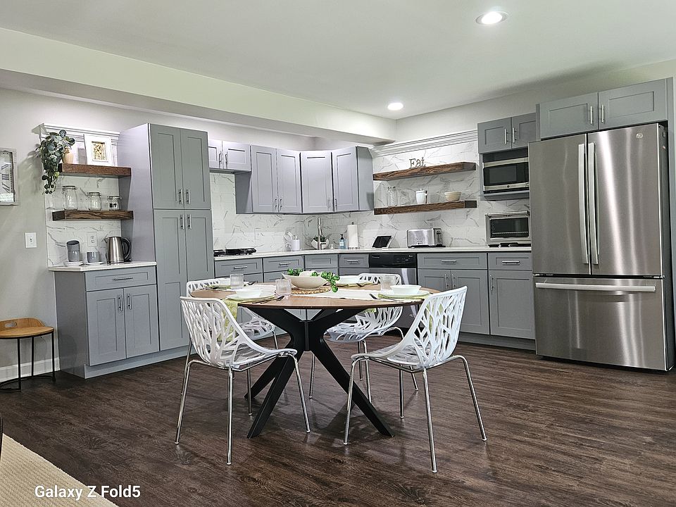 Stainless steel appliances include two induction cooktops, microwave, toaster, convection oven and a huge full size LG french door refrigerator/freezer.