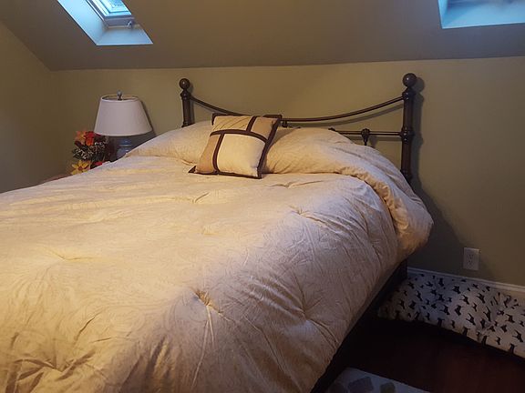 bedroom 2 with 2 skylights