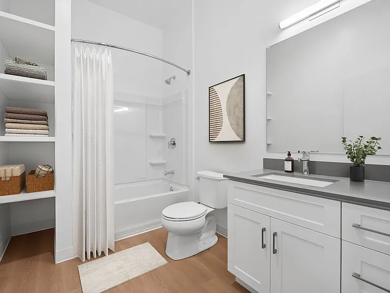 Upgrade Collection bath with white cabinetry, grey quartz countertop, and hard surface flooring
