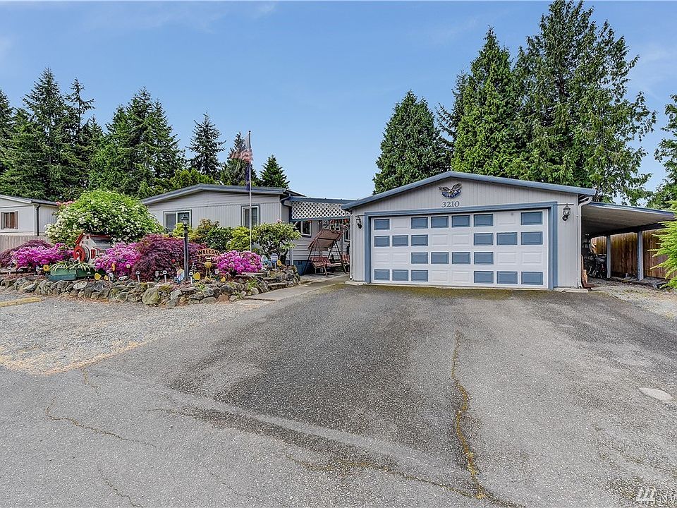 Welcome home! 2 car garage, extra parking in front and covered storage area to the right.  