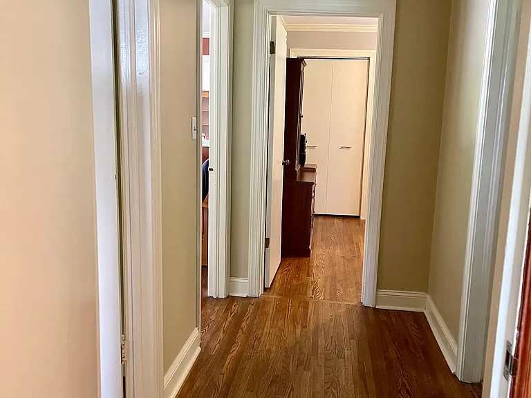 Hallway in center of the home connects 3 bedrooms, full bath and living room. There is a closet with adjustable wire shelves in the hallway as well as in this bath.