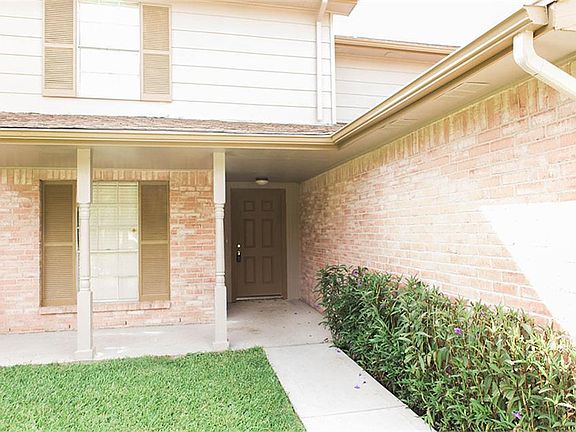 Beautiful curb appeal with a front porch and lush landscaping.