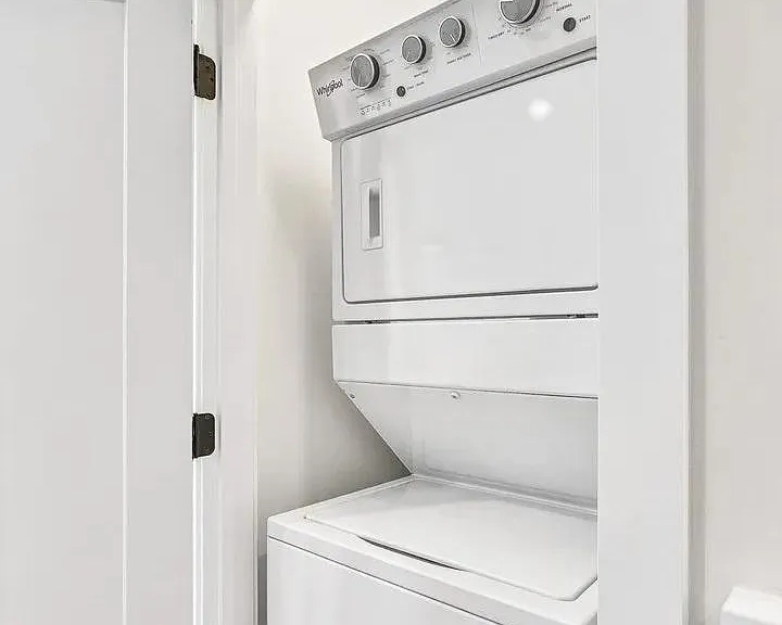 In-Unit Laundry: Convenient stacked Whirlpool washer and dryer