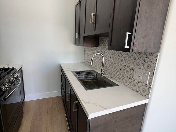 Kitchen sink. Plenty of kitchen cabinets.