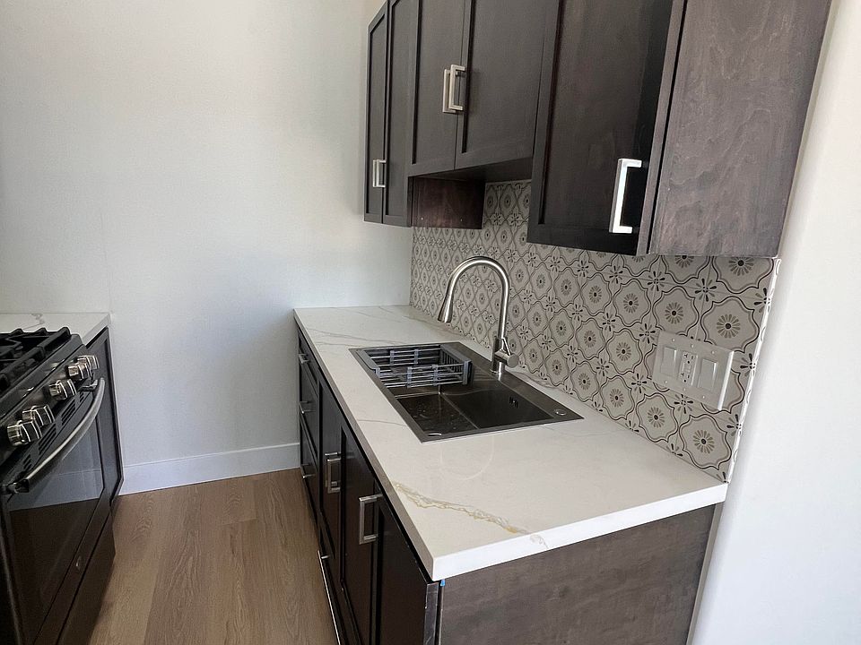 Kitchen sink. Plenty of kitchen cabinets.