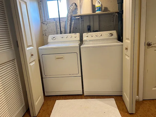 Washer, dryer, sink, and drying rack in basement