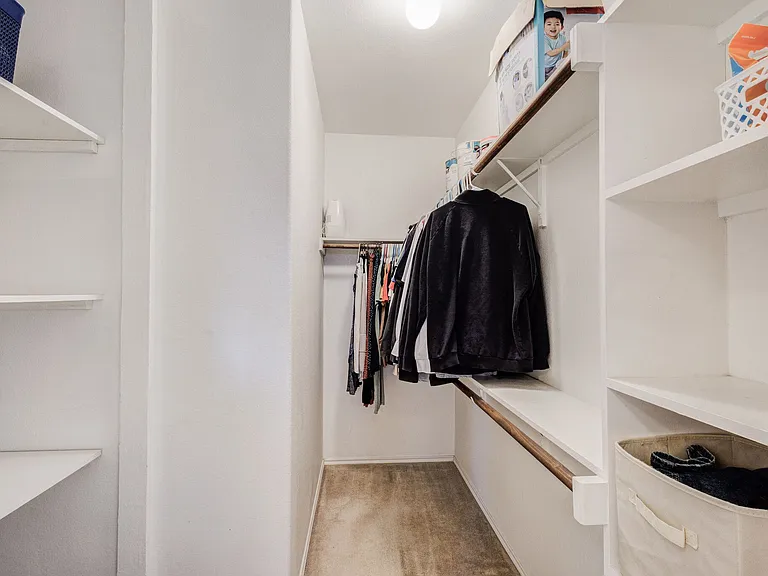 The primary closet is a walk-in closet with shelves for extra storage