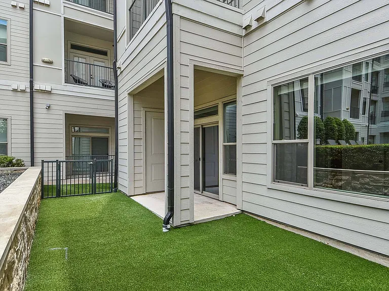 Unwind outdoors on the grassy patio, perfect for lounging, gathering, or soaking up the sun.
