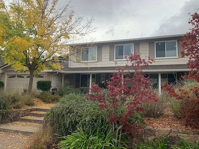 Front of home. Drought tolerant landscaping. Two car garage.