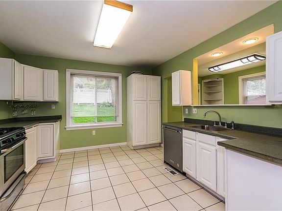 Kithcen has been completely renovated with white cabinetry, ceramic tile flooring and new appliances.