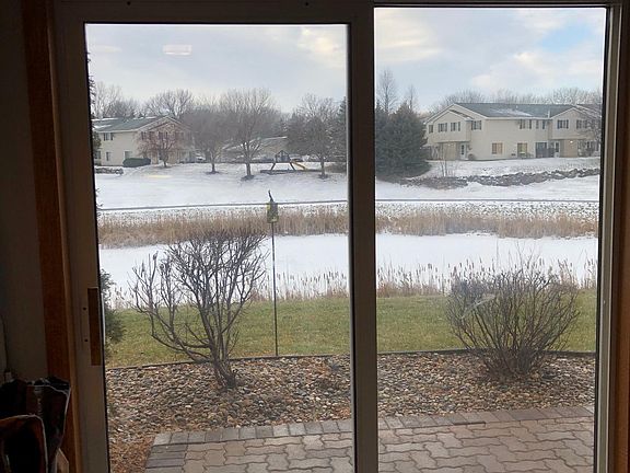 Sliding glass doors and patio overlooking pond and trails
