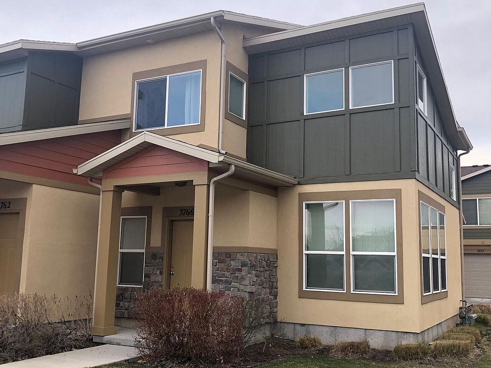 This is a view of the front of the house. You walk into the front room with big and spacious vaulted ceilings. It makes the space feel warm and cozy because of all the light that comes in. You will love this home!