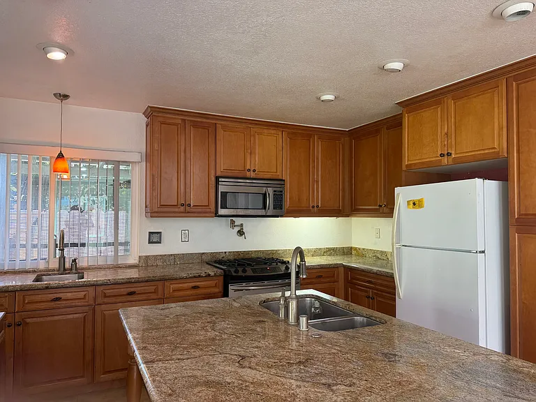 Kitchen has 2 sinks, microwave, dishwasher,
4 burner gas stove