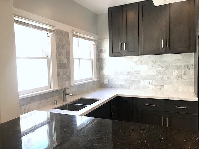 Calacata stone counter top, Carrara backsplash, granite bar counter