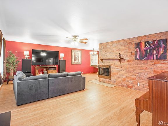 Beautiful entry into the living room with amazing laminate floors & cozy wood burning fireplace!