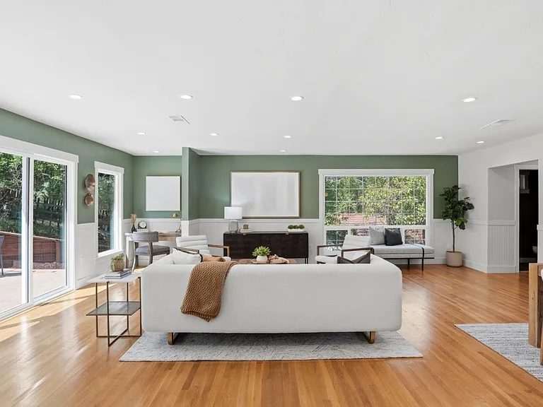 Expansive living room with serene backyard views