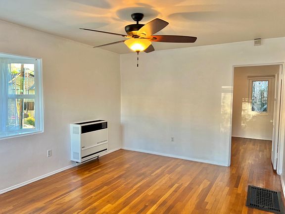 In this picture, the bedroom is straight ahead, and the kitchen is on the right