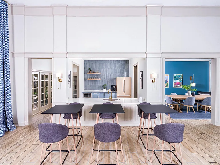A stylish community kitchen with open shelving and vibrant finishes_perfect for casual gatherings or hosting friends.