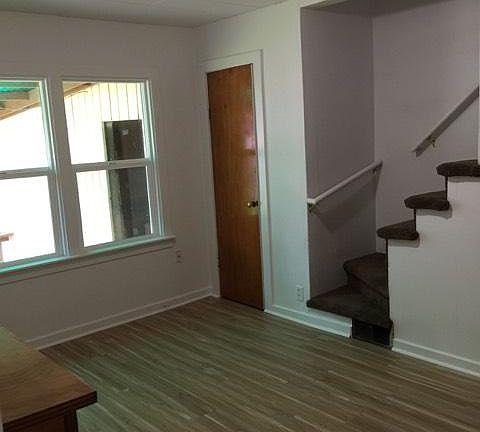 Bedroom number 2 with new flooring, with stairs to bonus roo
