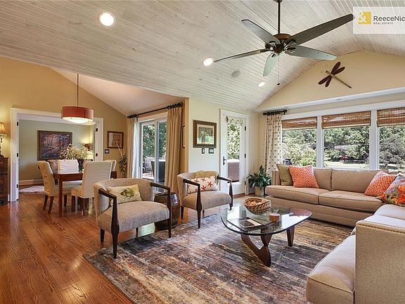 Completely renovated from top to bottom, this open living room with vaulted ceilings and huge windows is the perfect place to relax.