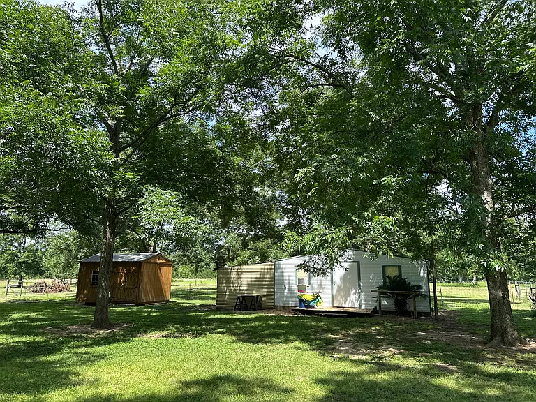White shed is for tools and storage. Left side of the Shed, the hang over has been enclosed and prepped to be used for a chicken coop. Has roosting bars and nesting boxes in it already.
Brown shed prepped to be home office or homeschool room.
