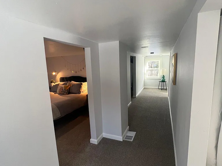 Upstairs hallway is spacious and open with windows on both ends to ensure natural light all day