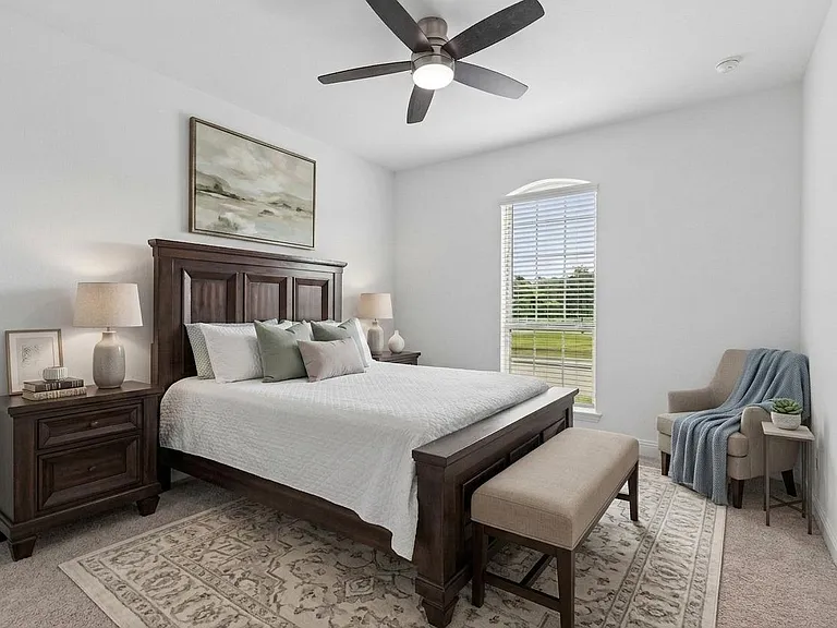 Secondary bedroom 2 located at the front of the home, separate from the primary bedroom. This photo has some virtual staging.