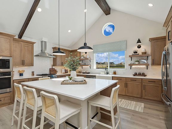 Kitchen with pendant lighting and stained ceiling beams