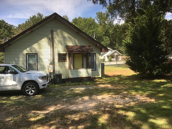 Backyard/ driveway, door leads into kitchen area