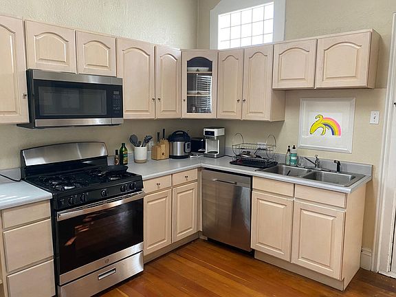 Kitchen has a new oven and dishwasher with lots of cabinet and counter space.