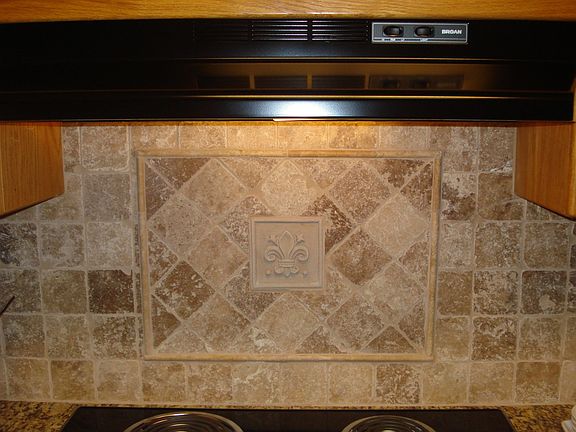 Natural Stone Backsplash w/Fleur-de-lis inset