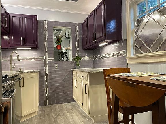 View of galley kitchen, expandable table included in rental