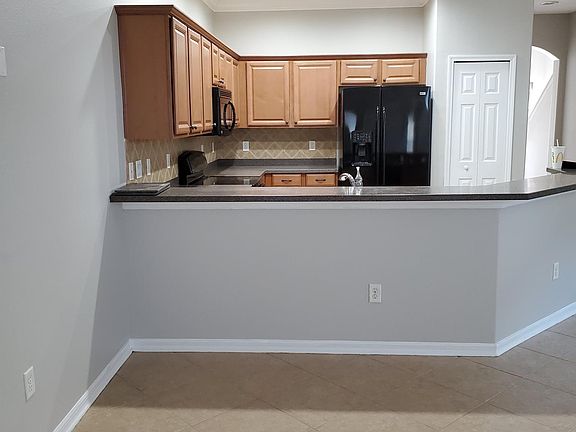 Kitchen opens to family room with seated bar area