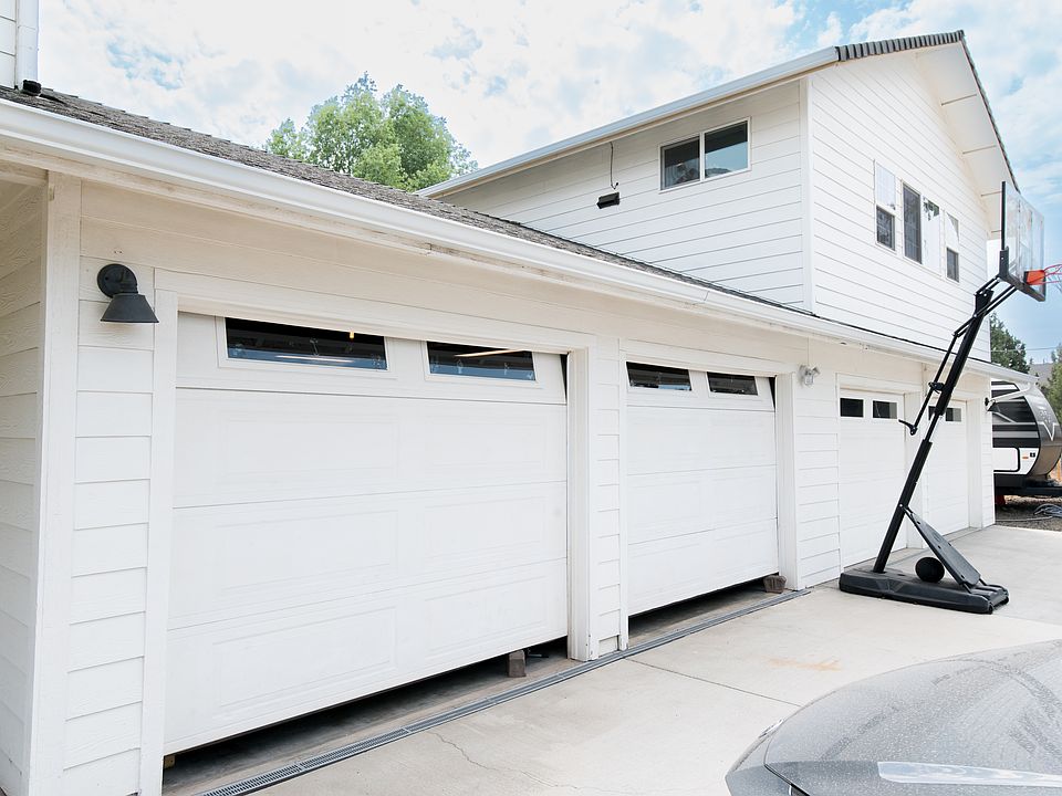 The two doors closest in this picture lead to the spacious two-car garage. Clean and painted "man cave"...the other two under the garage are separate one-car garages.