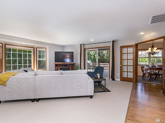 Big living room open to the kitchen and dining area just to the right. French doors to make it private if desired. Slider goes out to the covered deck and private backyard.