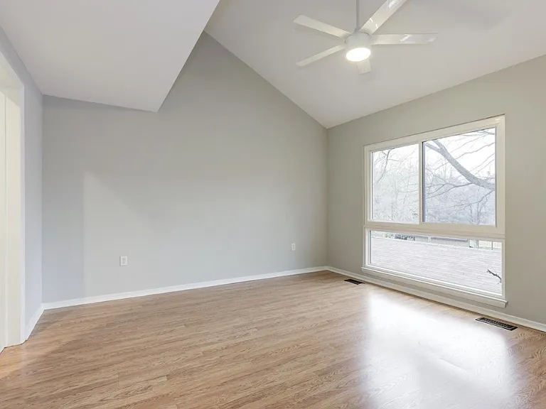 Master bathroom, where a large window frames a peaceful outdoor view, filling the space with natural light and a sense of calm. Thoughtfully designed with both style and function in mind, this private retreat features modern fixtures, ample counter space.