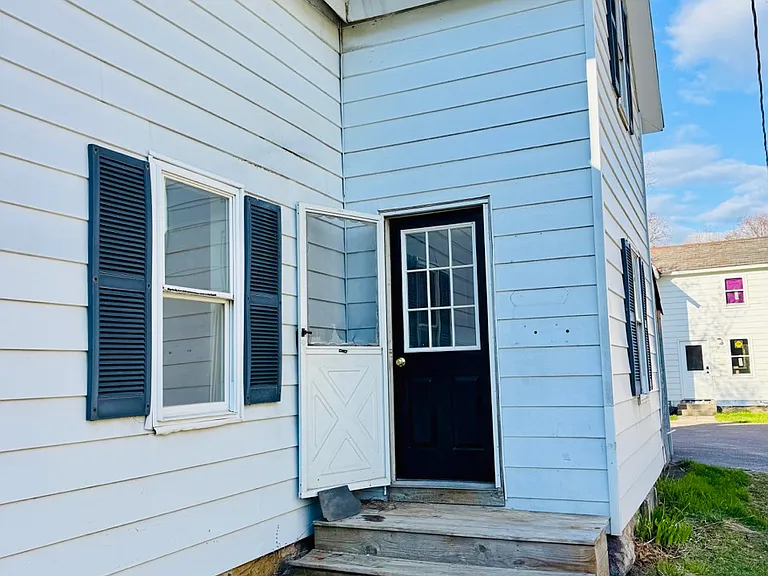 Entry into kitchen from driveway with off-street parking for 2-3 cars
