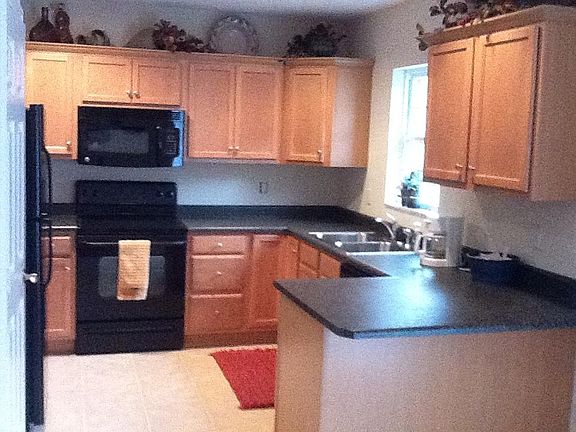 Spacious eat in kitchen with pantry. Microwave, electric stove, oven, refrigerator, garbage disposal and room for stools at the counter