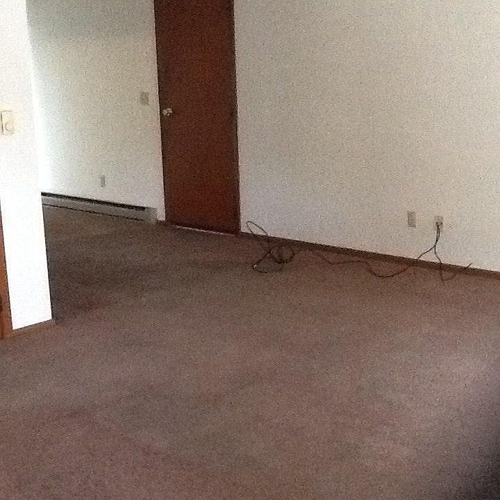 Living/dining area has door to garage & sliding glass doors