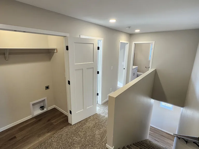 Laundry space directly off the upstairs landing (washer/dryer not pictured but provided). (Pictures are of another unit with similar finishes and features.)