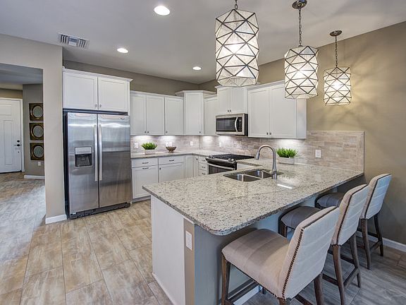 Model Representation Gourmet kitchen with stainless steel gas appliances quartz countertops