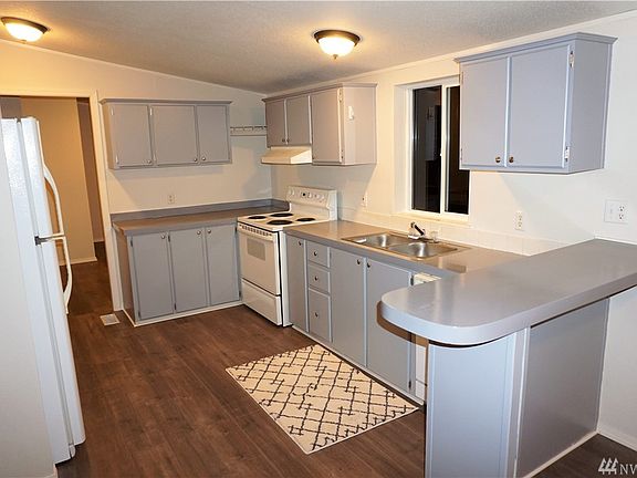 Freshly painted kitchen with utility room & pantry in the background.