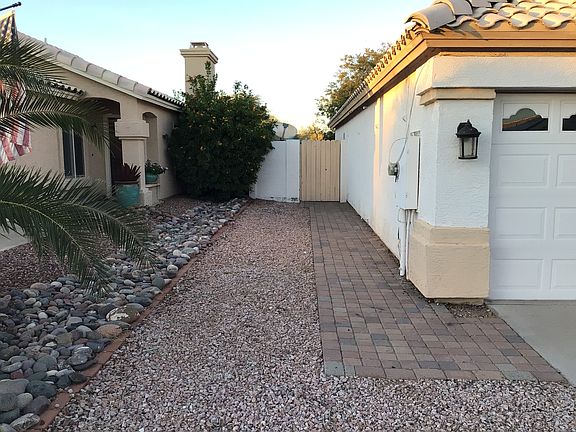 Paver walkway to backyard easy access with garbage cans