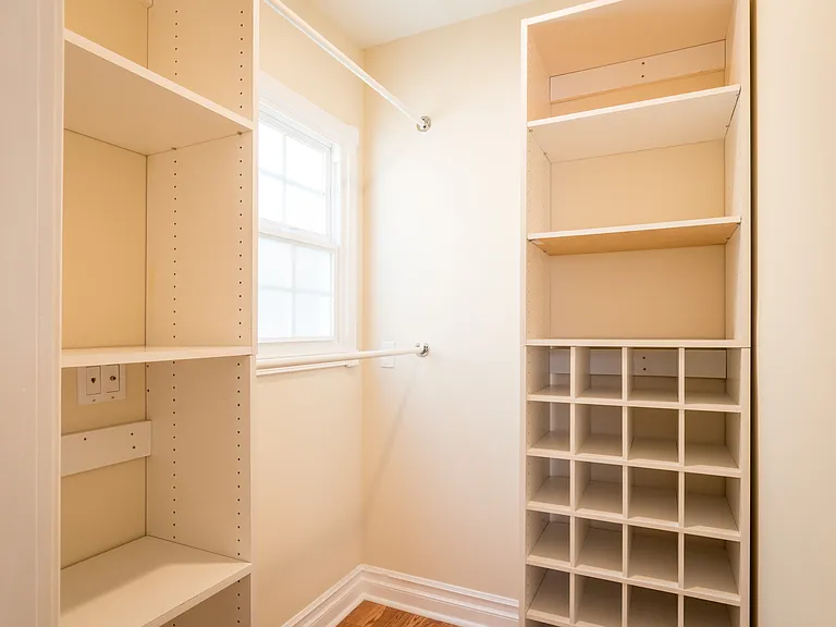 WALK IN CLOSET W/ TONS OF CUSTOM SHELVING, SHOW RACKS AND HANGING SPACE
