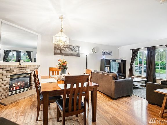 The cozy fireplace is situated so you can enjoy it from the living or dining space