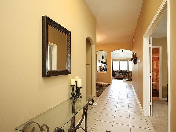 View from entry. Ceramic tile extends throughout entry, dining, living, and kitchen.